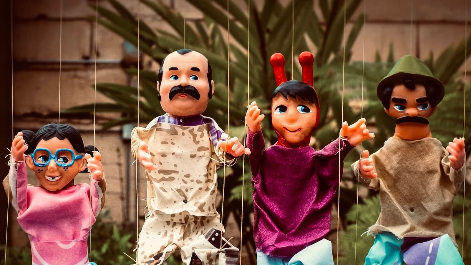 Puppets on strings. Via Evan Fitzer, Unsplash.
